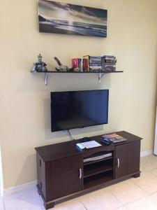 a flat screen tv on a wall in a room at Beach, Oceanfront, Flagler Beach Rental in Flagler Beach