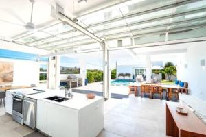 a kitchen and dining room with a view of the ocean at Beachside 3 Bedroom Villa with Pool and Resort Amenities - White Villas - v4 in Providenciales