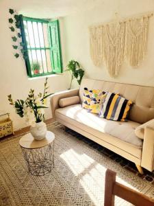 a living room with a couch and a table at Apartamento Cueva La Torre in Aldaia