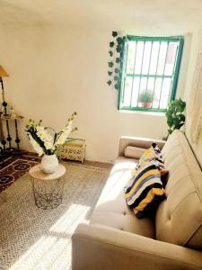 a living room with a couch and a window at Apartamento Cueva La Torre in Aldaia