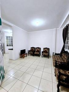 a living room with chairs and a tiled floor at Departamento amoblado excelente para familias in Puerto Baquerizo Moreno