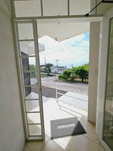 an open glass door with a view of a street at Departamento amoblado excelente para familias in Puerto Baquerizo Moreno