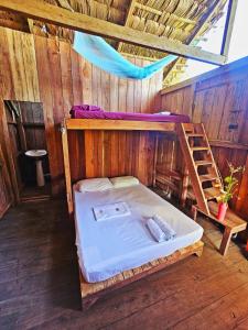 a room with a bunk bed and a ladder at Hakuna Matata Ecolodge in El Valle