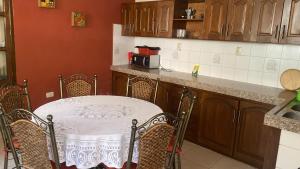a kitchen with a table and chairs and a counter at B&B SANTA CECILIA in Sucre