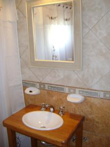 a bathroom with a sink and a mirror at Hosteria Cumelen in San Martín de los Andes