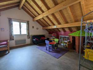 a large living room with wooden ceilings and a table at Gîte Saulxures-sur-Moselotte, 4 pièces, 6 personnes - FR-1-589-242 in Saulxures-sur-Moselotte
