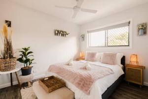 a bedroom with a large bed and a window at An Idyllic Boho Style Retreat High-end kitchenware in Gold Coast