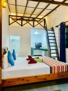 a bedroom with a large bed with a ladder at Indika Beach Villa in Galle