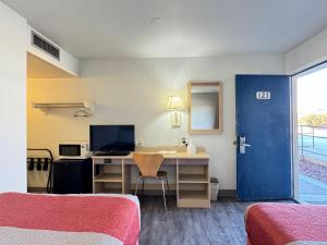 a room with two beds and a desk with a computer at Motel 6-Casper, WY in Casper
