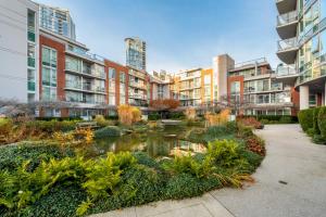 a garden in the middle of a city with tall buildings at Downtown 1 Bedroom Water View Condo in Vancouver