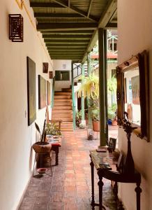 a hallway of a building with a table and chairs at Hotel Posada de San Agustin in Tunja