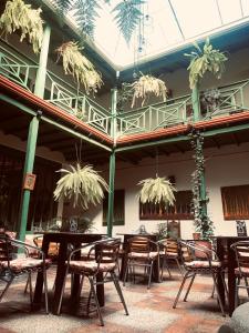a patio with tables and chairs in a building at Hotel Posada de San Agustin in Tunja +64 photos