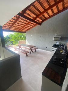 eine Küche mit einem Picknicktisch und einem Picknicktisch in der Unterkunft Nossa suíte - Praia da Pipa in Pipa