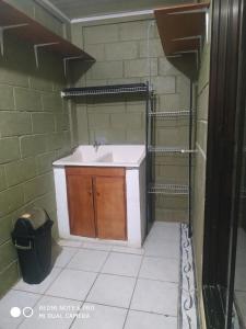 a bathroom with a sink and a trash can at Villa Zurí in Guanacaste