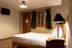 Postel nebo postele na pokoji v ubytování Hotel Casa del Fraile