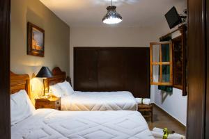 Postel nebo postele na pokoji v ubytování Hotel Casa del Fraile