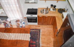 a kitchen with a stove and a counter top at 1 Bedroom Beautiful Home In Glemmingebro in Löderup