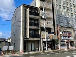 a tall building on a city street at Calm Stay Nijo in Kyoto