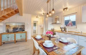 a kitchen and dining room with a wooden table and chairs at Nice Home In Wandlitz Ot Zerpenschl in Berg