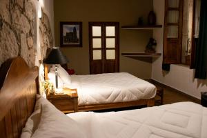 Postel nebo postele na pokoji v ubytování Hotel Casa del Fraile