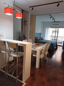 sala de estar con mesa blanca y sillas en Turismo Apart Palermo en Buenos Aires