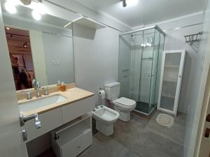 a bathroom with a sink and a toilet and a shower at Turismo Apart Palermo in Buenos Aires