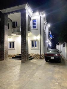 a car parked in front of a house at night at DIVINE VILLA AND RESORTS HOTEL GUEST House 15 mins Near Michael Okpara University Sam Mbakwe Airport in Umuhu