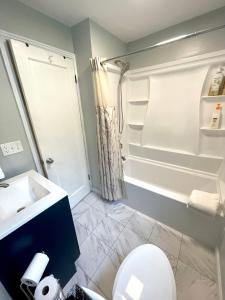 a bathroom with a toilet and a sink and a shower at Avenue of the Giants Caraway Cottage (#3) 