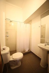 a bathroom with a toilet and a sink and a shower at Cusco el Conquistador in Cusco