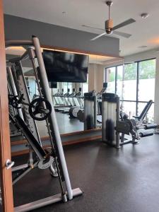 a gym with several tread machines and a mirror at H-Town Luxury w/ Pool in Houston