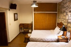 Postel nebo postele na pokoji v ubytování Hotel Casa del Fraile