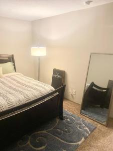 Schlafzimmer mit einem Bett und einem Spiegel in der Unterkunft Louisville Derby Special!! 2 Queen Bdr in Louisville