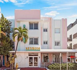 a large white building with a heron sign on it at Henrosa Hotel in Miami Beach