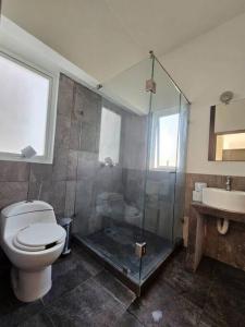 a bathroom with a shower and a toilet and a sink at Hermosa casa con vista al lago de Tequesquitengo !! in Tequesquitengo