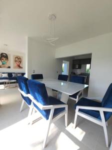 a dining room with a table and blue chairs at Hermosa casa con vista al lago de Tequesquitengo !! in Tequesquitengo