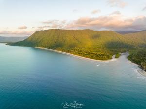 an aerial view of a body of water with a beach at Noah Creek Eco Huts in Cape Tribulation