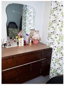 a dresser with a mirror on top of it at Private Annex, Little Flat, Private Entrance in Nottingham