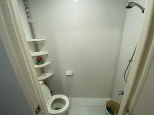 a white bathroom with a toilet and a shower at 3 Beds Filinvest Alabang in Manila