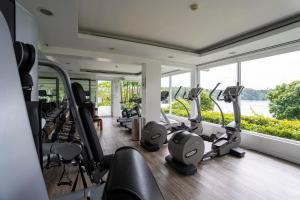 a gym with a bunch of treadmills and ellipticals at The Nai Harn in Nai Harn Beach
