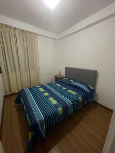 1 dormitorio con 1 cama con manta azul y amarilla en Apartamento privado pueblo libre, en Lima