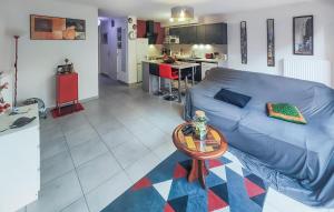 a living room with a blue couch and a table at 3 Bedroom Gorgeous Home In Agde in Agde