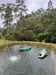 two canoes in the water in a pond at Glamping Villa del Bosque in Santa Rosa de Cabal