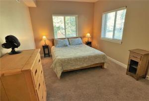 a bedroom with a bed and two windows at 3-Bedroom Luxury Condo in the Heart of the City in Salt Lake City