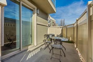 a patio with a table and chairs on a balcony at 3-Bedroom Luxury Condo in the Heart of the City in Salt Lake City