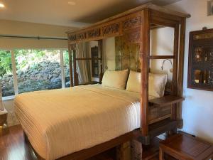 a bedroom with a wooden bed with a wooden frame at Private and Quiet Guest Apt in Hawaii Cloud Forest in Kailua-Kona