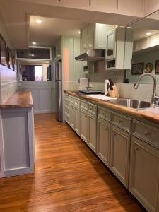 a kitchen with wooden floors and a large kitchen with a sink at Private and Quiet Guest Apt in Hawaii Cloud Forest in Kailua-Kona