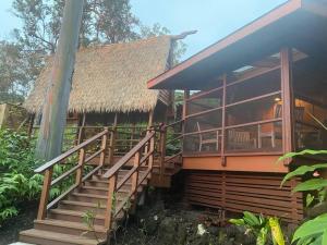 a house with a staircase leading up to it at Private and Quiet Guest Apt in Hawaii Cloud Forest in Kailua-Kona