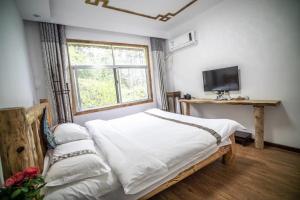 Zhangjiajie YOLO Resort--Within Zhangjiajie National Forest Park客房内的一张或多张床位