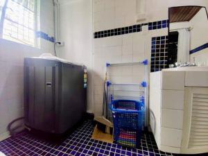 a bathroom with a sink and a blue tiled floor at Guesthouse in Suva in Suva