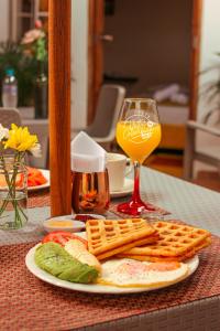 a plate of food and a glass of orange juice at Hostal Colombian Gold in San Gil
